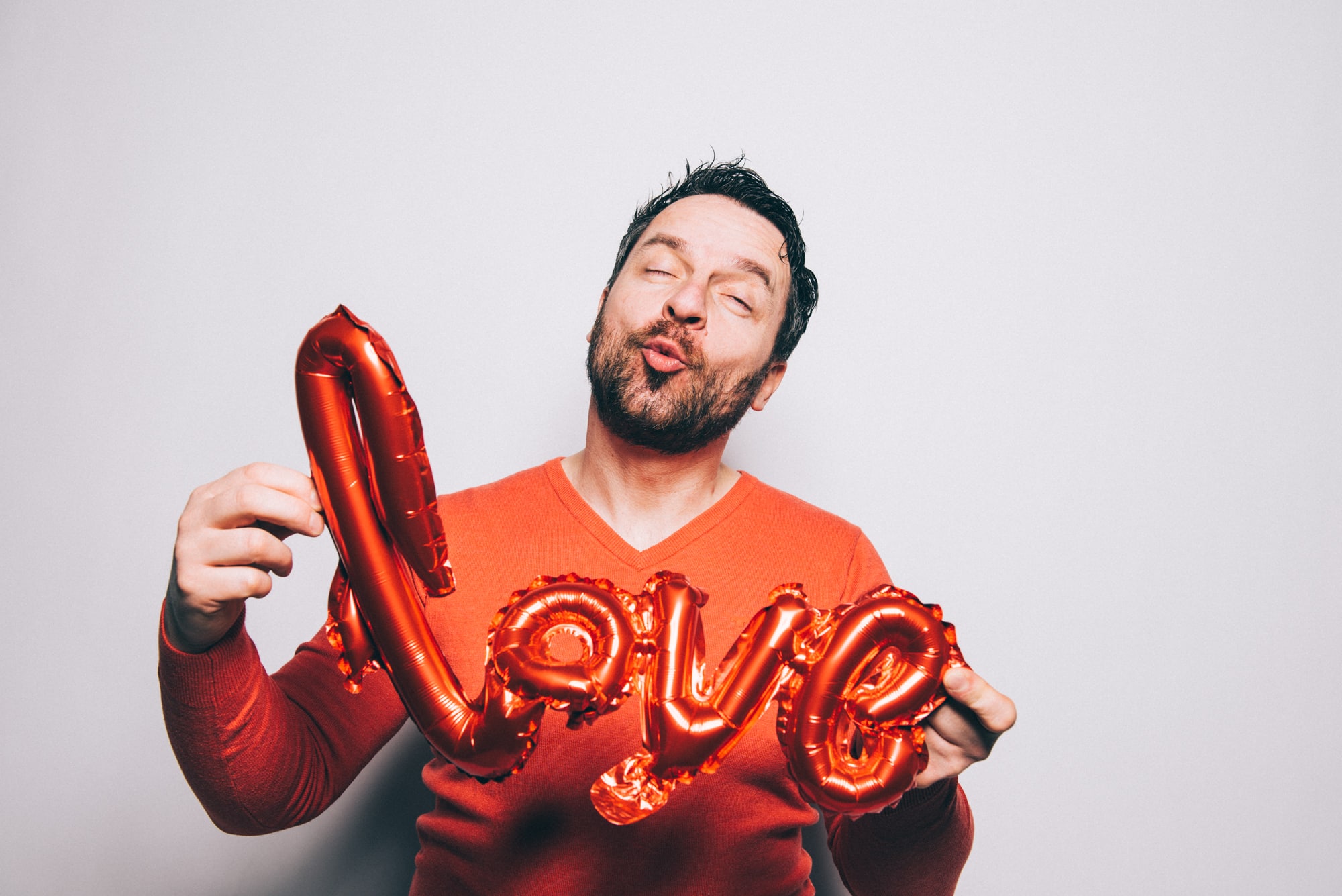 Mann mit Love Ballon Schriftzug Valentinstag